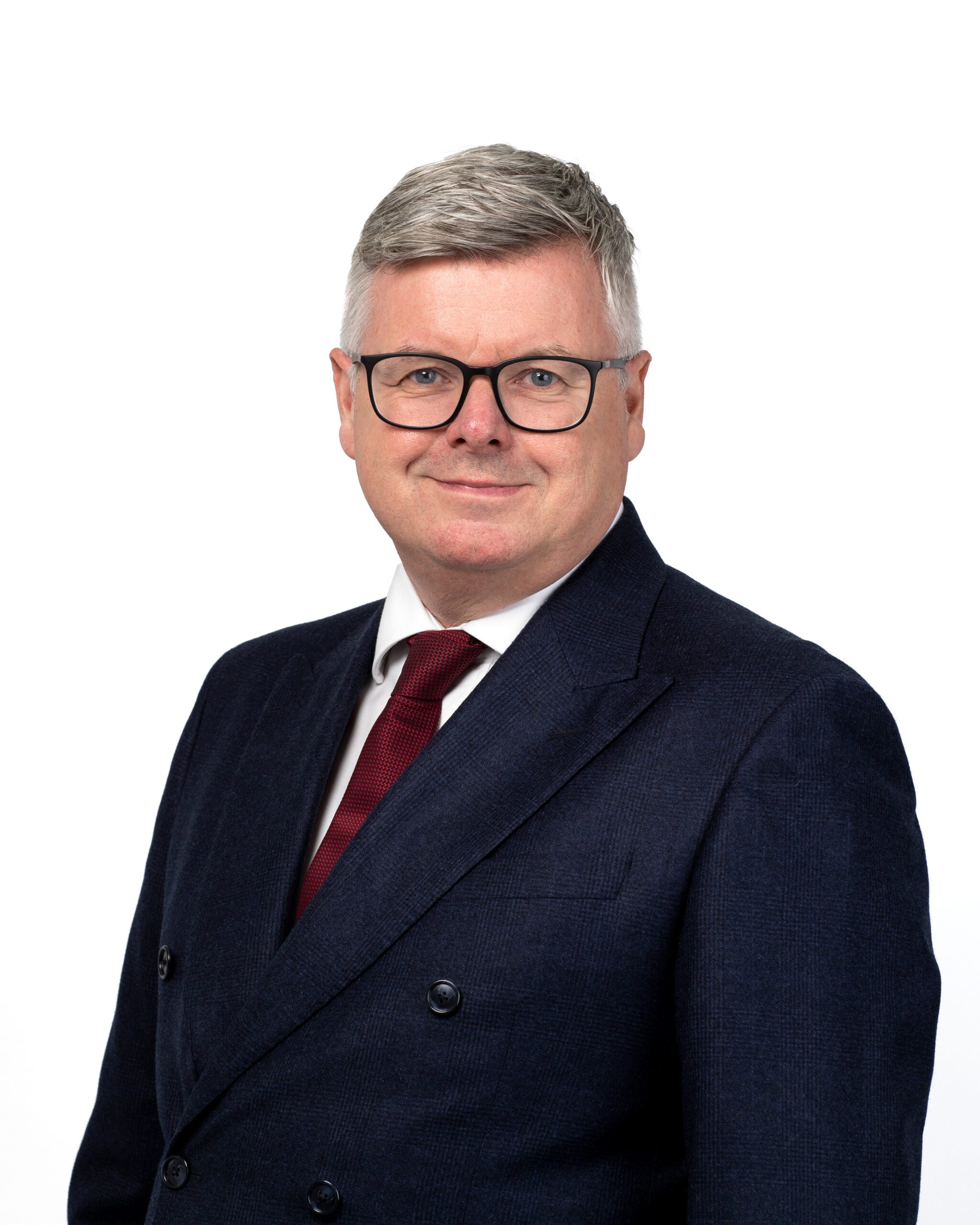a man smiling at the camera in a suit